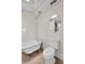 A well-lit bathroom with a classic clawfoot tub, beadboard walls, and vintage-style fixtures at 844 10Th S Ave, St Petersburg, FL 33701