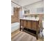 Bathroom with a wood vanity, framed mirror, and shower over the tub at 844 10Th S Ave, St Petersburg, FL 33701