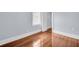 An empty bedroom with hardwood floors, a window, and white trim at 844 10Th S Ave, St Petersburg, FL 33701