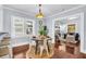 A dining area with a rustic table and three mirrors on the wall next to a view into the living room at 844 10Th S Ave, St Petersburg, FL 33701