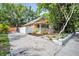 Charming yellow house with a front porch, landscaped yard, and driveway at 844 10Th S Ave, St Petersburg, FL 33701