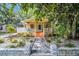 Charming yellow bungalow with lush landscaping, a cozy porch, and a welcoming walkway at 844 10Th S Ave, St Petersburg, FL 33701