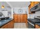 A kitchen featuring wooden cabinets, stainless steel appliances, and an elegant oversized wall clock at 844 10Th S Ave, St Petersburg, FL 33701