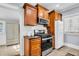 A compact kitchen with wooden cabinets, stainless steel appliances, and a classic white subway tile backsplash at 844 10Th S Ave, St Petersburg, FL 33701