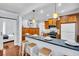 Well-equipped kitchen with wooden cabinetry, a breakfast bar, and an open view into other rooms at 844 10Th S Ave, St Petersburg, FL 33701