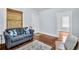 Comfortable living room with a blue sofa, hardwood floors, and natural light from windows at 844 10Th S Ave, St Petersburg, FL 33701