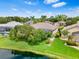 Aerial view of a home's backyard with a pond, mature trees, and screened-in patio at 8521 30Th E St, Parrish, FL 34219