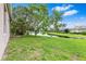 Spacious backyard with lush green lawn, mature trees, and serene waterfront views at 8521 30Th E St, Parrish, FL 34219