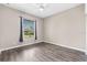 Bedroom with wood flooring, a ceiling fan, and a window overlooking the backyard at 8521 30Th E St, Parrish, FL 34219