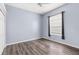 Bedroom featuring wood flooring, a ceiling fan, and a window overlooking the backyard at 8521 30Th E St, Parrish, FL 34219