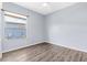 Bedroom with wood flooring, a ceiling fan, and a window overlooking the backyard at 8521 30Th E St, Parrish, FL 34219