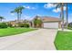 Well-maintained single-story home with a spacious driveway and manicured front yard landscaping at 8521 30Th E St, Parrish, FL 34219