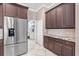Kitchen boasts stainless steel refrigerator, granite countertops and custom cabinets at 8521 30Th E St, Parrish, FL 34219