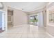 Spacious living room features tile flooring, neutral paint, sliding glass door with backyard pool views at 8521 30Th E St, Parrish, FL 34219