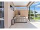 Outdoor patio with built-in kitchen, grill, mini-fridge, and views of the lake at 8521 30Th E St, Parrish, FL 34219