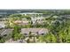 An aerial view of townhomes near a lake with a fountain and surrounded by mature trees at 9418 W Park Village Dr # 105, Tampa, FL 33626