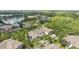 Aerial view of townhomes near a lake with fountain and green trees at 9418 W Park Village Dr # 105, Tampa, FL 33626