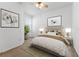Bedroom featuring a ceiling fan, neutral carpet, and two framed art pieces at 9418 W Park Village Dr # 105, Tampa, FL 33626