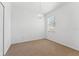 Minimalist bedroom design with neutral carpet, a chandelier, and ample natural light at 9418 W Park Village Dr # 105, Tampa, FL 33626