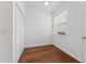 Empty bedroom with hardwood floors, natural light, and closet space at 9418 W Park Village Dr # 105, Tampa, FL 33626