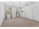 Bright bedroom with two windows, neutral carpet, and decorative chandelier at 9418 W Park Village Dr # 105, Tampa, FL 33626