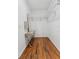 Walk-in closet with custom shelving, laminate wood floor, and natural light at 9418 W Park Village Dr # 105, Tampa, FL 33626