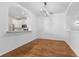 Bright dining room with wood floors, stylish chandelier, and open view to the modern kitchen at 9418 W Park Village Dr # 105, Tampa, FL 33626