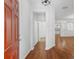 Welcoming entryway with hardwood floors and bright, neutral paint, leading to other rooms in the house at 9418 W Park Village Dr # 105, Tampa, FL 33626