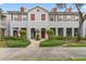 Charming townhome with manicured landscaping, red shutters, and inviting front entrances at 9418 W Park Village Dr # 105, Tampa, FL 33626