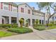 Charming townhome with manicured landscaping, red shutters, and inviting front entrances at 9418 W Park Village Dr # 105, Tampa, FL 33626