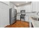Well-equipped kitchen featuring stainless steel appliances, white cabinetry, and granite countertops at 9418 W Park Village Dr # 105, Tampa, FL 33626