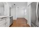 The kitchen offers stainless appliances and marble countertops, opening up to a dining space with wood floors at 9418 W Park Village Dr # 105, Tampa, FL 33626