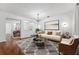 Bright living room features stylish furniture, a modern chandelier, and decor for a comfortable and inviting space at 9418 W Park Village Dr # 105, Tampa, FL 33626