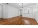 Large living room with hardwood floors featuring an open floor plan and modern light fixture at 9418 W Park Village Dr # 105, Tampa, FL 33626