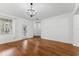 Spacious living room with hardwood floors and natural light from a nearby window at 9418 W Park Village Dr # 105, Tampa, FL 33626