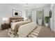 Cozy main bedroom features a plush bed, decorative artwork, and bright windows at 9418 W Park Village Dr # 105, Tampa, FL 33626