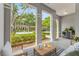 Cozy patio area with striped rug, comfortable seating, and views of the landscaped front yard at 9418 W Park Village Dr # 105, Tampa, FL 33626