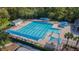 Aerial view of a large swimming pool area with lap lanes, spa, lounge chairs, and shady canopies at 9418 W Park Village Dr # 105, Tampa, FL 33626