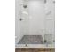 Glass enclosed shower featuring mosaic flooring, rain shower head, and built-in niche at 9418 W Park Village Dr # 105, Tampa, FL 33626