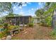 A charming backyard with a screened-in porch and lush landscaping, perfect for outdoor living and relaxation at 9602 N Rome Ave, Tampa, FL 33612