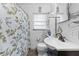 Bright bathroom featuring a pedestal sink, toilet and tub/shower combo at 9602 N Rome Ave, Tampa, FL 33612