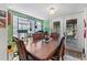 Comfortable dining area with a view to the backyard, light fixtures, and stylish decor at 9602 N Rome Ave, Tampa, FL 33612