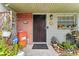 Welcoming front door with brick accent, adorned with plants, creating a warm and inviting entrance at 9602 N Rome Ave, Tampa, FL 33612