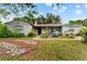 Charming home exterior featuring a cozy front yard and colorful landscaping, creating a welcoming curb appeal at 9602 N Rome Ave, Tampa, FL 33612