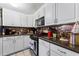 Well-equipped kitchen featuring white cabinetry, modern appliances, and ample counter space at 9602 N Rome Ave, Tampa, FL 33612