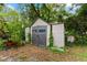 Backyard storage shed with double doors, perfect for storing tools and gardening supplies at 9602 N Rome Ave, Tampa, FL 33612