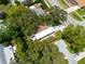 Aerial view of home showcasing mature trees and landscaped yard at 10095 Oakhurst Rd, Seminole, FL 33776