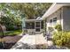Relaxing backyard patio with outdoor seating, landscaping, and a convenient screened-in porch at 10095 Oakhurst Rd, Seminole, FL 33776