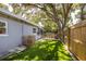 Private backyard with stone pavers, artificial turf, and a lovely fenced area at 10095 Oakhurst Rd, Seminole, FL 33776