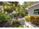 Serene backyard with a stone pathway, a play area, and mature trees at 10095 Oakhurst Rd, Seminole, FL 33776
